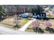 Sprawling property featuring a lovely home, detached garage, beautiful landscaping, and inviting driveway at 105 Glasgow Dr, Clayton, NC 27520