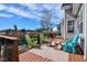 Staged outdoor deck area with wood floors, green Adirondack chairs, and a fire pit overlooking the lake at 105 Glasgow Dr, Clayton, NC 27520