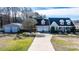 Charming home featuring an attached two-car garage, detached garage, and a spacious driveway at 105 Glasgow Dr, Clayton, NC 27520