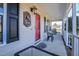 Inviting front porch featuring a red door, black shutters, and a cozy seating area at 105 Glasgow Dr, Clayton, NC 27520