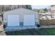 Two car garage with two garage doors with a fenced backyard area adjacent to the garage at 105 Glasgow Dr, Clayton, NC 27520