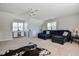 Large living room with neutral walls and carpet, a ceiling fan and lots of light at 105 Glasgow Dr, Clayton, NC 27520