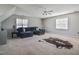 Spacious living room with neutral carpet, lots of light and a comfortable couch at 105 Glasgow Dr, Clayton, NC 27520