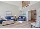 Open-concept living room with vaulted ceilings, hardwood floors, and nautical-themed decor at 105 Glasgow Dr, Clayton, NC 27520