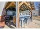 Covered outdoor kitchen with stools at the bar, a grill and outdoor decor at 105 Glasgow Dr, Clayton, NC 27520