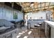 Well equipped outdoor kitchen featuring a grill, mini fridge, plenty of prep area and bar seating at 105 Glasgow Dr, Clayton, NC 27520