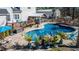 An in-ground pool featuring a tiki bar, rock waterfall, and various poolside lounge chairs at 105 Glasgow Dr, Clayton, NC 27520