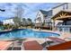 An in-ground pool featuring a tiki bar, rock waterfall, and various poolside lounge chairs at 105 Glasgow Dr, Clayton, NC 27520