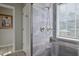Modern shower with gray tile, a hand-held sprayer, and a clear glass enclosure at 105 Glasgow Dr, Clayton, NC 27520