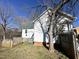 Backyard view with a white home, wooden fence, and lush greenery at 108 Holt St, Hillsborough, NC 27278