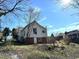 Home with a sloped backyard featuring greenery and white siding at 108 Holt St, Hillsborough, NC 27278