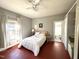 Comfortable bedroom with ceiling fan, gray walls, and natural light from a window at 108 Holt St, Hillsborough, NC 27278