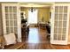A bright dining room and kitchen seen through vintage French doors at 108 Holt St, Hillsborough, NC 27278