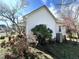 Exterior featuring white siding, green roof, and surrounding foliage at 108 Holt St, Hillsborough, NC 27278
