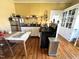 Vintage kitchen featuring white cabinets, stainless steel refrigerator, and black gas range at 108 Holt St, Hillsborough, NC 27278