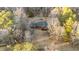 Aerial view of a single-Gathering home with an attached garage surrounded by trees and a fence at 1117 Pine Trl, Clayton, NC 27520