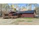 View of back of house featuring screened-in porch and wooden deck with pergola and hot tub at 1117 Pine Trl, Clayton, NC 27520