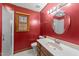 Cozy bathroom with a wooden vanity and sink, a circular mirror, and a shower at 1117 Pine Trl, Clayton, NC 27520