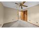 Bedroom with neutral carpet, ceiling fan, and closet with louvered doors at 1117 Pine Trl, Clayton, NC 27520