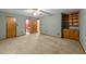 Spacious bedroom with soft carpet, ceiling fan, and a built-in shelving unit, offering comfort and storage at 1117 Pine Trl, Clayton, NC 27520