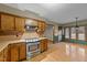 Eat-in kitchen featuring wood cabinets and stainless steel oven at 1117 Pine Trl, Clayton, NC 27520
