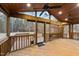 Spacious screened-in porch with a ceiling fan, wooden ceiling, and a wooded view at 1117 Pine Trl, Clayton, NC 27520