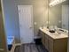Bathroom with double sink vanity, tub, and wood-look floors at 1208 Shining Water Ln, Creedmoor, NC 27522