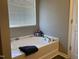 Relaxing bathroom featuring a large soaking tub and a window at 1208 Shining Water Ln, Creedmoor, NC 27522