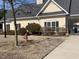 Charming exterior view of a cream-colored building with black shutters, neatly landscaped at 1208 Shining Water Ln, Creedmoor, NC 27522