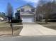 Charming two-story home featuring a stone facade and well-manicured front lawn at 1208 Shining Water Ln, Creedmoor, NC 27522