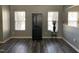 Open-concept living room with wood flooring, neutral paint, and natural light at 1208 Shining Water Ln, Creedmoor, NC 27522