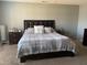 Cozy bedroom featuring a comfortable bed with a decorative headboard and soft carpet at 1208 Shining Water Ln, Creedmoor, NC 27522