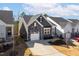 Aerial view of a home with a stone and siding exterior, a one-car garage, and a well-kept front yard at 1215 White Flint Cir, Durham, NC 27703