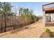 A large backyard with trees and a view of the home from the grassy outdoor space at 1215 White Flint Cir, Durham, NC 27703