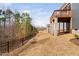 A large backyard with a black fence and some trees and home in the background at 1215 White Flint Cir, Durham, NC 27703