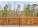 Backyard view with a nice wooden fence and a landscape with many trees at 1215 White Flint Cir, Durham, NC 27703