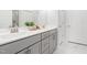 Bathroom featuring double sink vanity with gray cabinets and marble floors at 1215 White Flint Cir, Durham, NC 27703