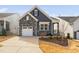 Charming home featuring stone accents, a one-car garage, landscaped yard, and a covered front entry at 1215 White Flint Cir, Durham, NC 27703