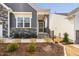 Charming home featuring a covered front porch with stone steps and well-maintained landscaping at 1215 White Flint Cir, Durham, NC 27703