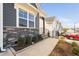 Home showcasing a stone facade, concrete walkway, and manicured landscaping, providing curb appeal at 1215 White Flint Cir, Durham, NC 27703