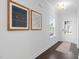 Inviting hallway with dark wood floors, white walls, and natural light from a front door at 1215 White Flint Cir, Durham, NC 27703