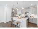 Modern kitchen with stainless steel appliances, quartz counters, and gray cabinets at 1215 White Flint Cir, Durham, NC 27703