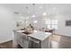 Open-concept kitchen and dining area with stainless steel appliances and gray cabinets at 1215 White Flint Cir, Durham, NC 27703