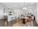 Open-concept kitchen and dining area with stainless steel appliances and modern finishes at 1215 White Flint Cir, Durham, NC 27703