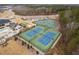 Aerial view of multiple well-maintained tennis courts and amenities in a community setting with natural backdrop at 1215 White Flint Cir, Durham, NC 27703