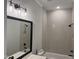 Updated bathroom with a sleek vanity, modern lighting, and a tiled shower/tub combo at 122 Sanderway Dr, Chapel Hill, NC 27516
