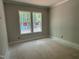 Bedroom view with double windows providing natural light and a view of trees at 122 Sanderway Dr, Chapel Hill, NC 27516
