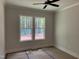 Comfortable bedroom with two windows providing natural light and views of the outdoors at 122 Sanderway Dr, Chapel Hill, NC 27516