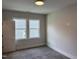 Carpeted bedroom featuring recessed lighting and a double window offering exterior views of the home next door at 122 Sanderway Dr, Chapel Hill, NC 27516