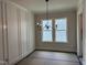 Dining room with wainscoting and a modern chandelier, offering a comfortable eating area at 122 Sanderway Dr, Chapel Hill, NC 27516